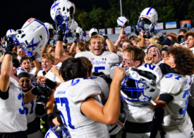 St. Xavier football players celebrate after defeating Elder in Week 6.