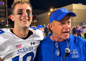 St. Xavier quarterback Thomas George and head coach Steve Specht celebrate after the Bombers' 31-29 win over Elder.