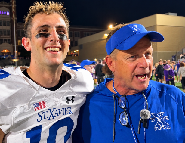 St. Xavier quarterback Thomas George and head coach Steve Specht celebrate after the Bombers' 31-29 win over Elder.
