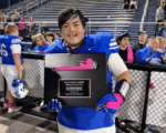 Simon Kenton senior lineman Anthony Sparkman holds the rivalry trophy after the Pioneers’ win over Ryle.