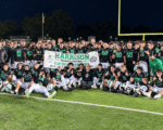 arrison football players and coaches pose with their SWOC championship banner after defeating Northwest 41-13.